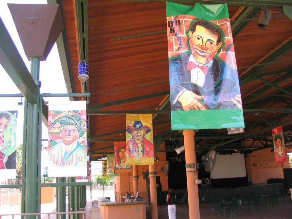 Robbin Robertson's musician portrait banners hanging at Sunset Station San Antonio