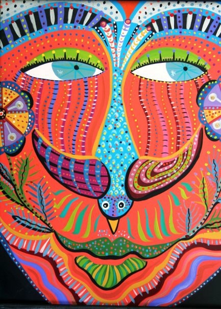 Vibrant colorful face mask painting with intricate patterns