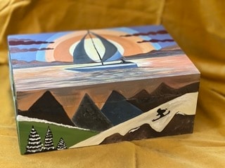 Painted wooden box with sailboat, mountains and skier scene