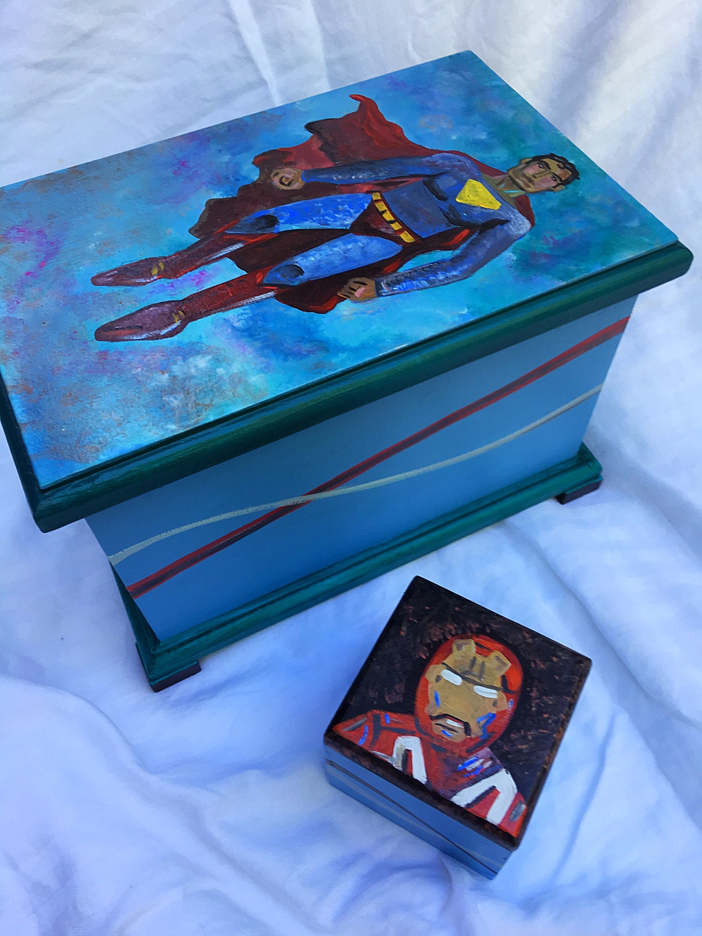 Hand-painted superhero wooden boxes featuring Superman and Iron Man